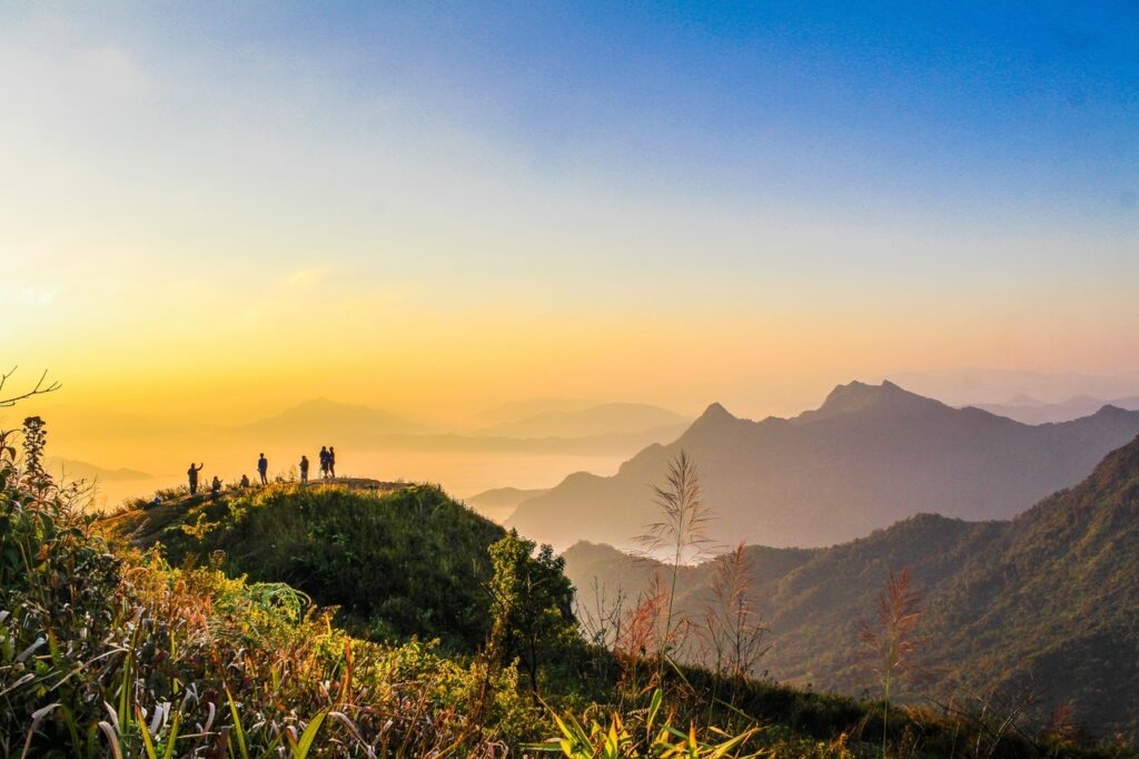 Photo Of People Standing On Top Of Mountain Near Grasses 733162 1024x682